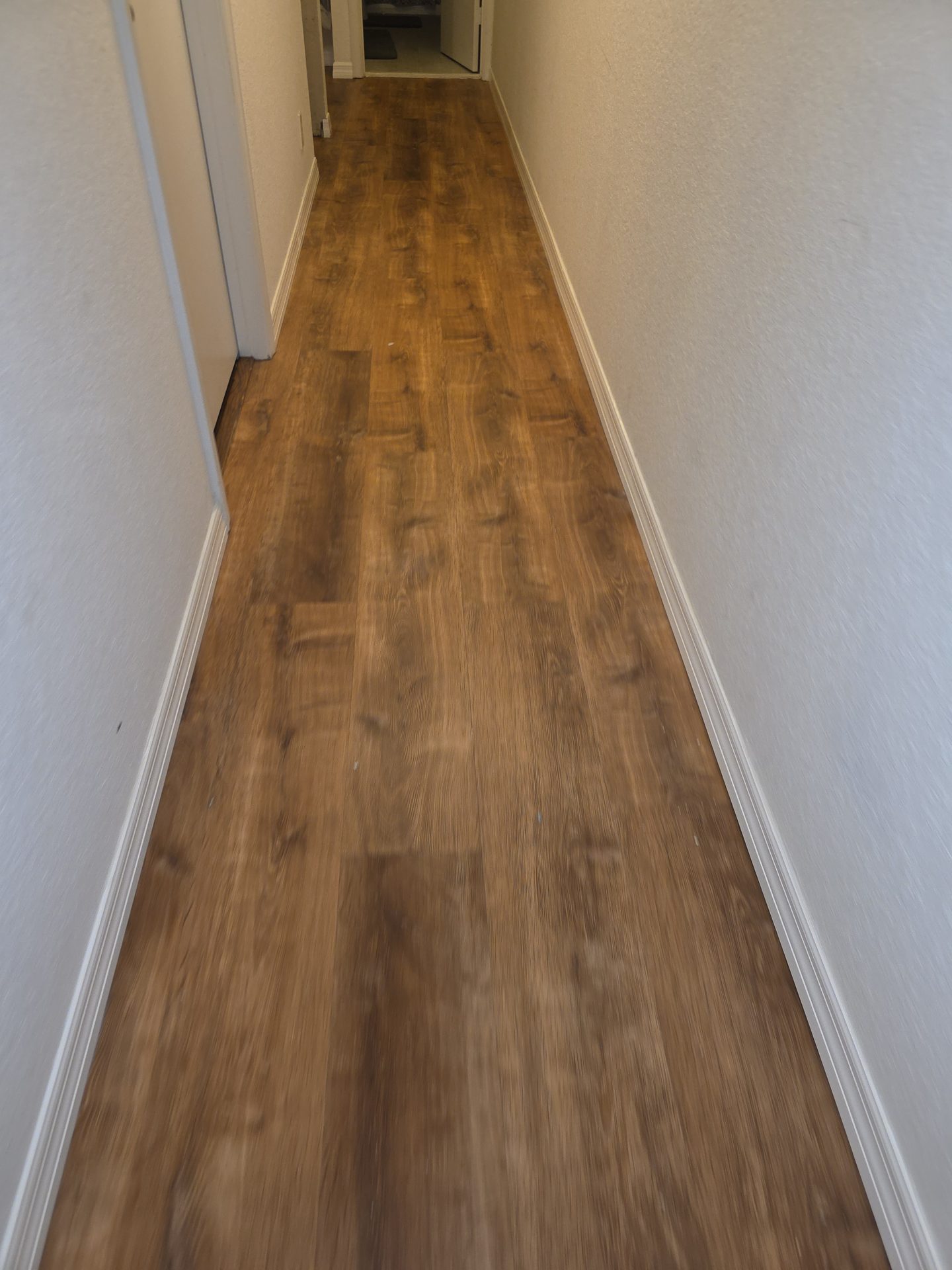 Wood-look vinyl plank flooring installed by Firenova